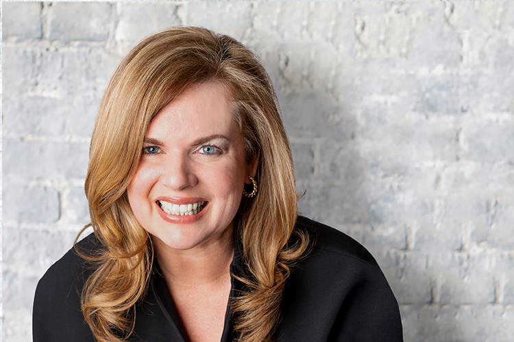 Dorenda McNeil headshot on white brick background