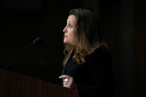 Chrystia Freeland speaking in front of a black background