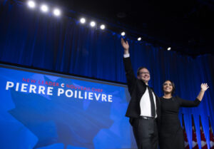 Pierre Poilievre and his wife Anaida wave on stage after he was announced as the winner of the Conservative Party of Canada leadership vot