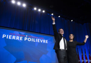 Pierre Poilievre and his wife Anaida wave on stage after he was announced as the winner of the Conservative Party of Canada leadership vote