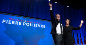 Pierre Poilievre and his wife Anaida wave on stage after he was announced as the winner of the Conservative Party of Canada leadership vote