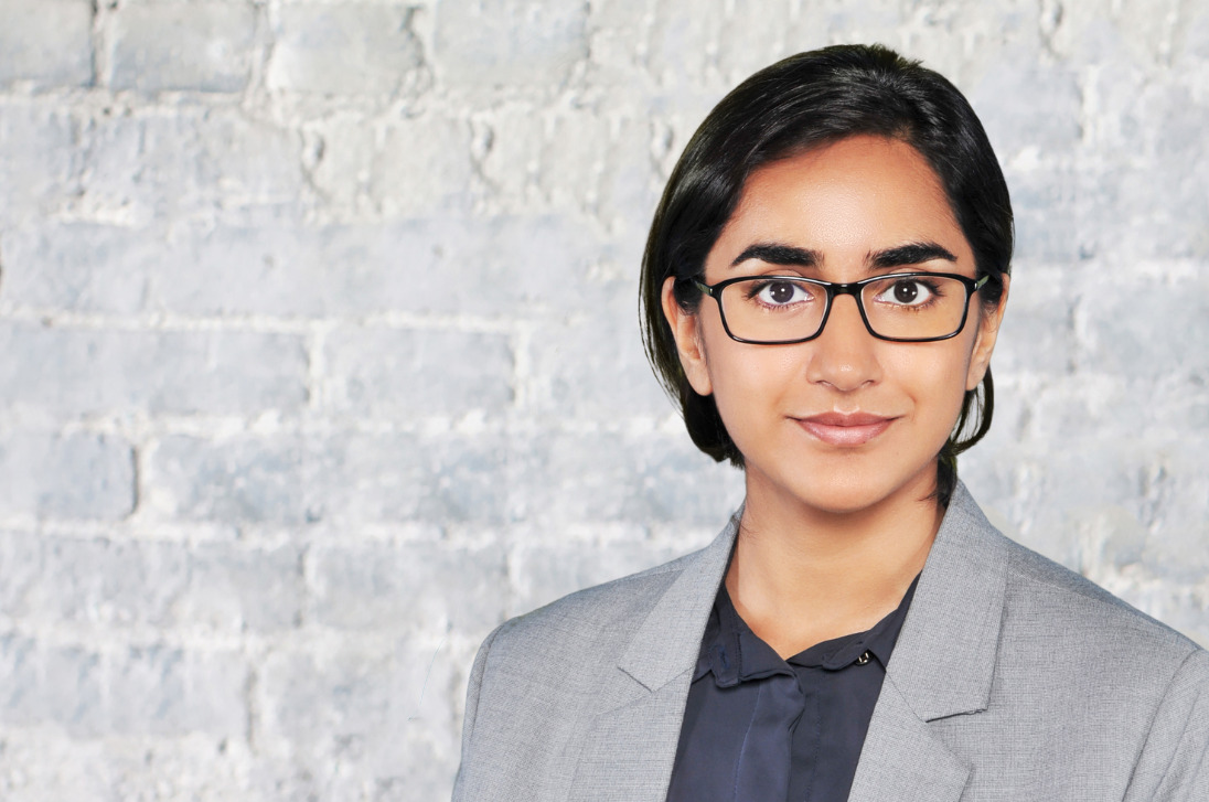 Headshot of Jignasha Gohilagainst a white brick background