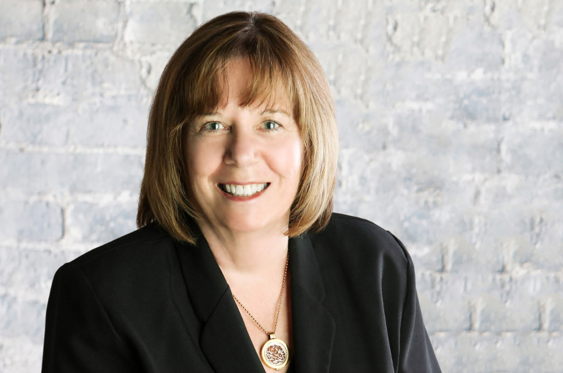 Marg McCuaig-Boyd Headshot on white brick background