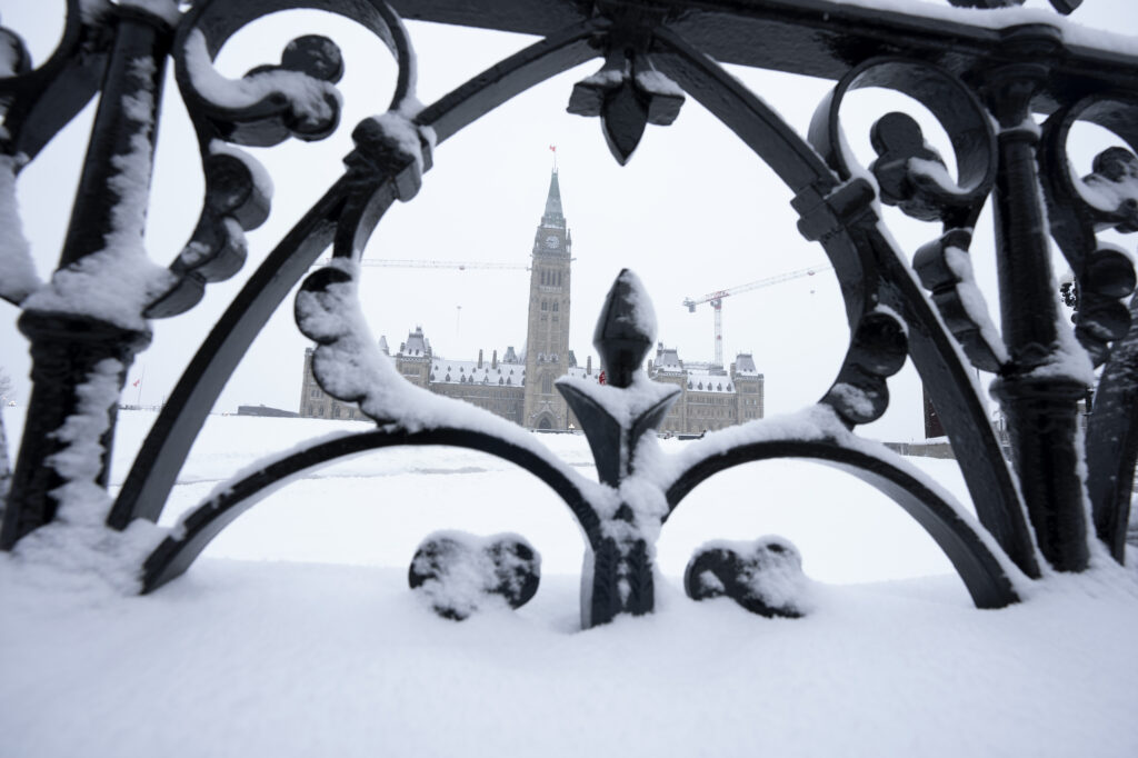Snow covers a fence surrounding Parliament Hill in Ottawa, Friday, January 20, 2023. The federal government posted a $5.5 billion during the first nine months of the fiscal year. THE CANADIAN PRESS/Adrian Wyld