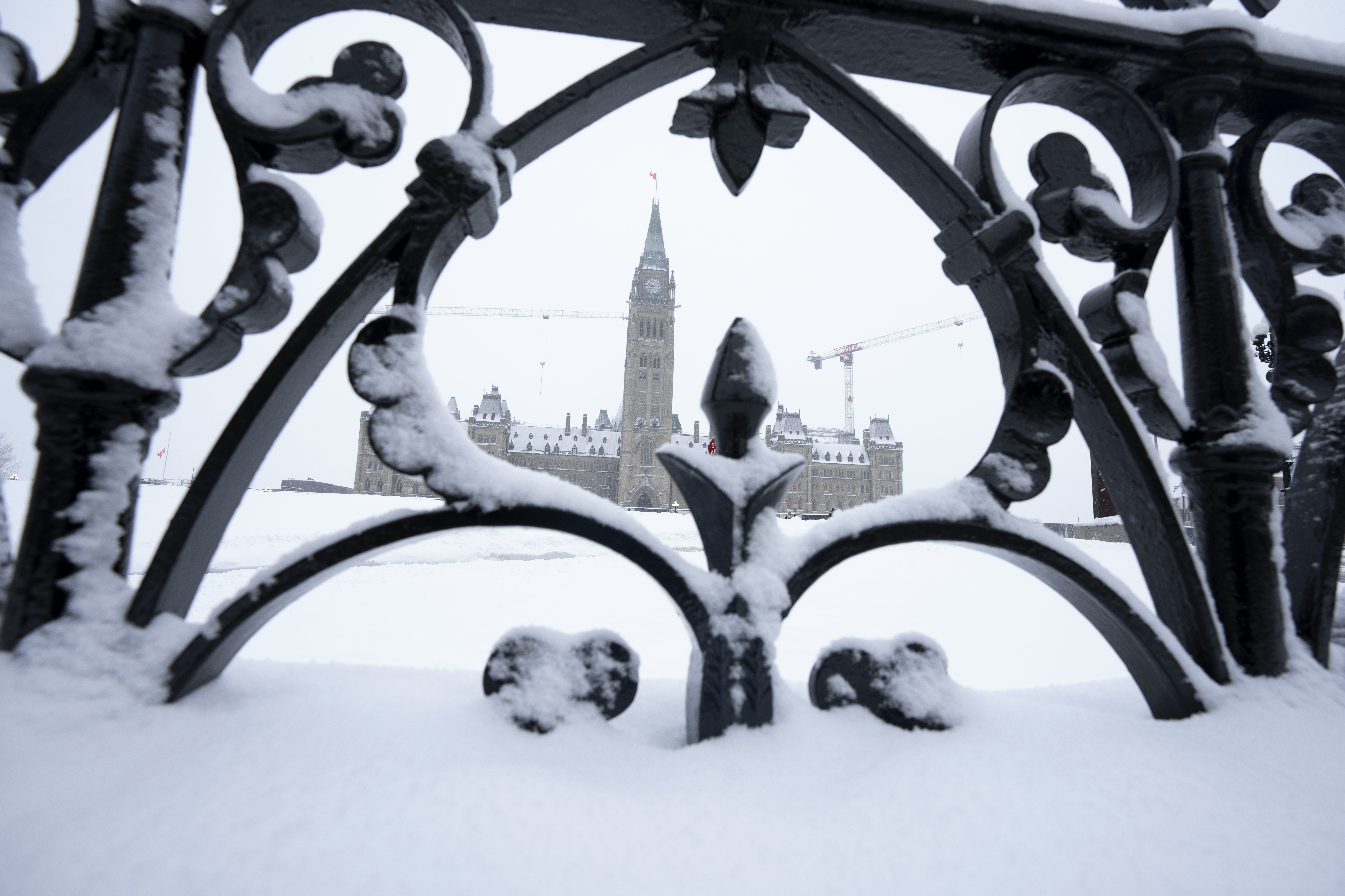 Snow covers a fence surrounding Parliament Hill in Ottawa, Friday, January 20, 2023. The federal government posted a $5.5 billion during the first nine months of the fiscal year. THE CANADIAN PRESS/Adrian Wyld